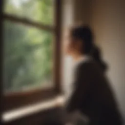 A person gazing out a window, contemplating their thoughts